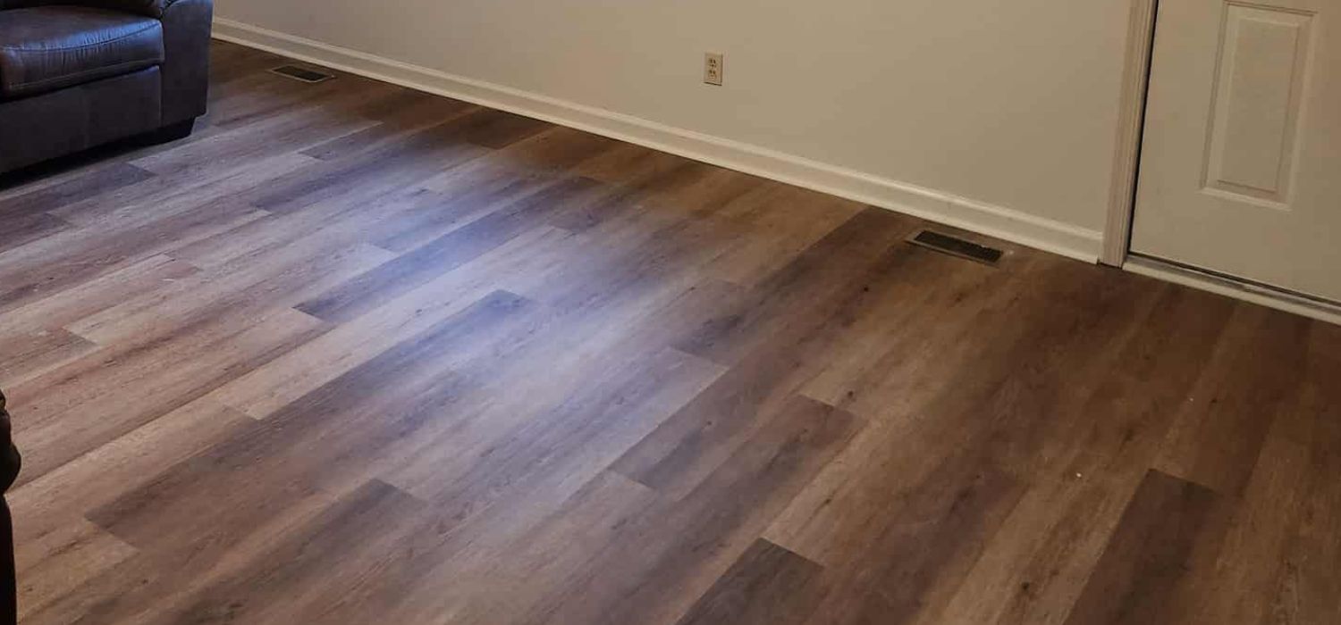 Installed luxury vinyl plank flooring in a residential living area, offering a moisture-resistant surface designed to handle foundation-related movement.